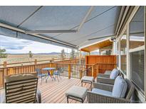 Relaxing deck area with comfortable seating and scenic mountain views at 15226 W 93Rd Ave, Arvada, CO 80007