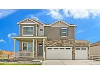 Charming two-story home featuring a stone facade, neutral siding, a welcoming porch, and a three-car garage at 226 Chardon Ave, Brighton, CO 80601