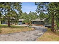 Charming ranch-style home with mature trees, spacious driveway, and inviting entryway at 21859 Grandview Ave, Golden, CO 80401