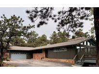 Charming single-story home with a 2-car garage and a beautifully landscaped front yard, offering serene mountain living at 21859 Grandview Ave, Golden, CO 80401