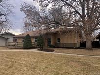 Charming one-story home with a well-maintained lawn and mature trees at 2045 S Monroe St, Denver, CO 80210