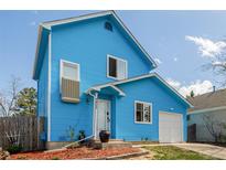 Charming two-story blue house with white trim, a manicured yard, and an attached garage at 4922 S Rifle Ct, Aurora, CO 80015