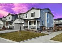 Two-story house with gray siding, stone accents, and a front porch at 24281 E 40Th Ave, Aurora, CO 80019