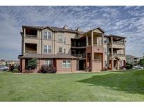 Spacious multi-story condo with multiple balconies, brick accents, and well maintained green space at 12914 Ironstone Way # 201, Parker, CO 80134
