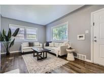 Bright living room features hardwood floors, neutral walls, and stylish, comfortable seating at 1388 Kenton, Aurora, CO 80010