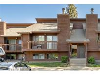 Two-story townhouse boasts wood facade, a balcony, and well-maintained landscaping, offering an inviting curb appeal at 2636 Juniper Ave # 39-1, Boulder, CO 80304