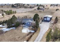 Expansive property featuring a ranch style home, detached garage, long driveway, and views of the surrounding landscape at 42926 Vista Rdg, Parker, CO 80138