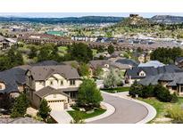 Wide angle view of homes in a neighborhood with city and mountain views at 2115 Holmby Ct, Castle Rock, CO 80104