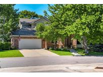 Charming brick home with mature landscaping and a spacious driveway at 74 Blue Heron Dr, Greenwood Village, CO 80121