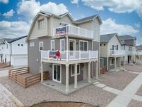 New two-story home boasts dual balconies, neutral siding, and stylish architectural details at 13625 E 103Rd Pl, Commerce City, CO 80022