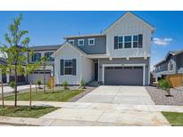 Beautiful two-story home featuring a two-car garage, modern design, and well-maintained landscaping at 9081 Telluride Ct, Commerce City, CO 80022