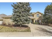 Two-story brick home with a large driveway and landscaping at 2457 S Xenon Way, Denver, CO 80228