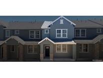 Charming townhome showcasing detailed trim work, neutral siding and complementary stone accents on the covered front porch at 17123 W 91St Ln, Arvada, CO 80007
