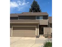 Charming townhome featuring a two-car garage and neutral-tone exterior for a welcoming curb appeal at 14131 E Baltic Pl, Aurora, CO 80014