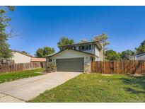 Two-story home featuring an attached two-car garage and a well-maintained front lawn at 16623 E Asbury Pl, Aurora, CO 80013