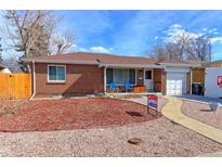 Charming single-story brick home with a well-maintained front yard and a cozy, inviting appeal at 1470 S Eaton St, Lakewood, CO 80232