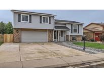 Charming two-story home featuring an attached two-car garage, well-maintained lawn, and inviting entryway at 450 Lone Pine St, Fort Lupton, CO 80621