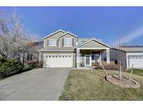 Charming two-story home with a well-maintained front yard and inviting covered porch at 10061 Apollo Bay Way, Highlands Ranch, CO 80130