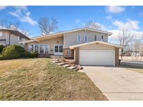 Charming two-story home with a well-manicured lawn and attached two-car garage at 2943 S Verbena Way, Denver, CO 80231