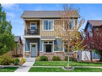 Charming two-story home with a cozy front porch and well-manicured lawn and inviting curb appeal at 4589 Quandary Peak St, Brighton, CO 80601