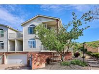 Charming condo with a two-car garage, featuring a well-maintained exterior and an inviting brick-accented entryway at 1629 S Deframe St # B8, Lakewood, CO 80228