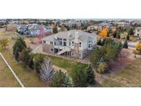 Expansive backyard on a two-story house with stone accents and lush landscaping in a desirable community at 6425 Tremolite Dr, Castle Rock, CO 80108