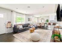 Bright and airy living room with open floor plan, hardwood floors, and modern decor at 5885 S Huron St, Littleton, CO 80120