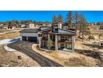 Modern home with 3-car garage, situated on a hillside lot with mountain views at 5820 Powell Rd, Parker, CO 80134