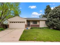 Charming single-story home with a well-manicured lawn and attached two-car garage at 4994 S Independence Way, Littleton, CO 80123
