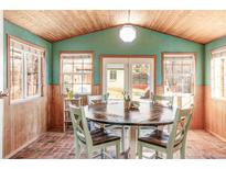 Bright sunroom features a round table, chairs, and brick flooring at 305 N Columbine St, Golden, CO 80403