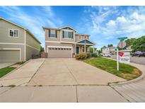 Charming two-story home with a well-manicured lawn and beautiful landscaping at 11091 Clayton St, Northglenn, CO 80233