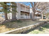 Charming condo exterior featuring multiple balconies and a well-maintained lawn at 18391 E Kepner Pl # 205, Aurora, CO 80017