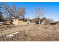 Ranch style home with mature trees and a large yard at 2753 S Meade St, Denver, CO 80236