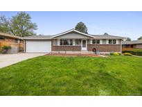 Charming single-story home with a well-maintained lawn, brick accents, and a two-car garage at 1185 Yank St, Golden, CO 80401