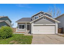 Charming two-story home featuring a well-manicured lawn and an attached two-car garage at 1716 W Sunset St, Longmont, CO 80501