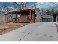 Charming single-story home featuring a covered front porch and well-maintained landscaping at 3290 S Holly St, Denver, CO 80222