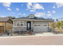 Charming single-Gathering home with grey siding, stone accents, and a two-car garage at 1610 Cade Ave, Castle Rock, CO 80104