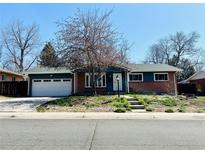 Charming brick home with a two-car garage and well-maintained front yard at 2964 S Yates St, Denver, CO 80236