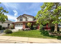 Charming two-story home with a well-manicured lawn, mature trees, and a cozy front porch at 2912 Lake Park Way, Longmont, CO 80503