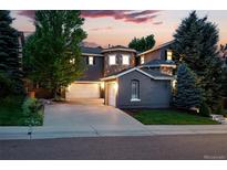Beautiful exterior view of a multi-story home, enhanced by mature trees and a well-manicured lawn at 2832 Danbury Ave, Highlands Ranch, CO 80126