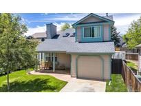 Charming two-story home with a front porch and well-manicured lawn, perfect for outdoor relaxation and curb appeal at 13323 Birch Cir, Thornton, CO 80241