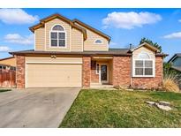 Charming two-story home with a well-maintained lawn and attached two-car garage at 4014 S Kirk Way, Aurora, CO 80013