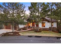 Inviting home with stone accents, lush lawn, mature trees, and a warm, welcoming atmosphere at 646 Ruby Trust Dr, Castle Rock, CO 80108