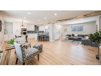 Open-concept living space with modern kitchen, dining area, and comfortable seating, creating a welcoming atmosphere at 5895 S Huron St, Littleton, CO 80120