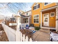 Cute yellow townhome with a fenced patio, perfect for relaxing at 911 Snowberry St, Longmont, CO 80503