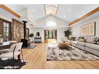 Inviting living room featuring a stone fireplace, skylight and window seat at 8782 S Ault Ln, Morrison, CO 80465