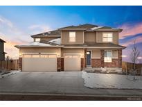 Beautiful two-story home featuring a three-car garage, brick accents and a landscaped front yard at 13328 Xanthia St, Thornton, CO 80602