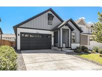 Charming craftsman style home with a two-car garage and landscaped front yard at 27840 E 7Th Pl, Aurora, CO 80018