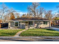 Charming ranch home featuring a well-manicured lawn and walkway leading to the front door at 5500 Holland Dr, Arvada, CO 80002