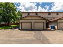 Charming exterior view of the home showcasing the attached two-car garage at 902 S Yukon St, Lakewood, CO 80226